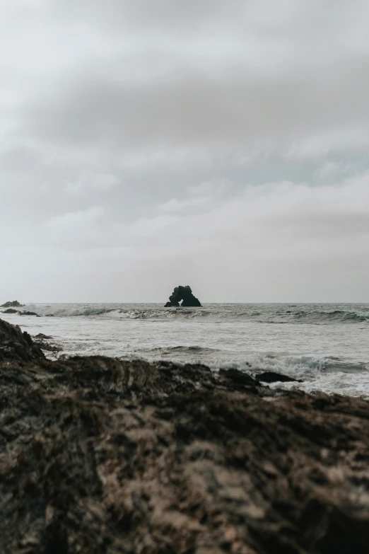 an island off the coast is seen on a cloudy day