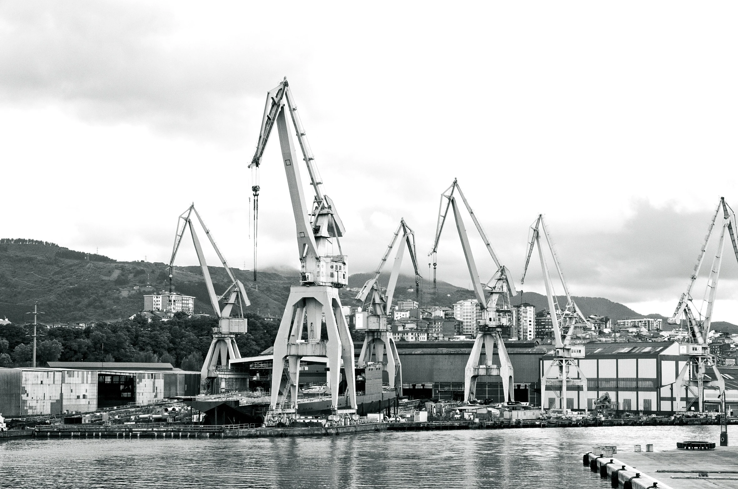 the crane tower and dock in black and white