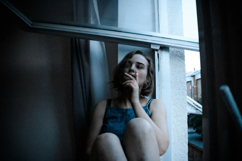 a woman in a short blue dress talking on the phone