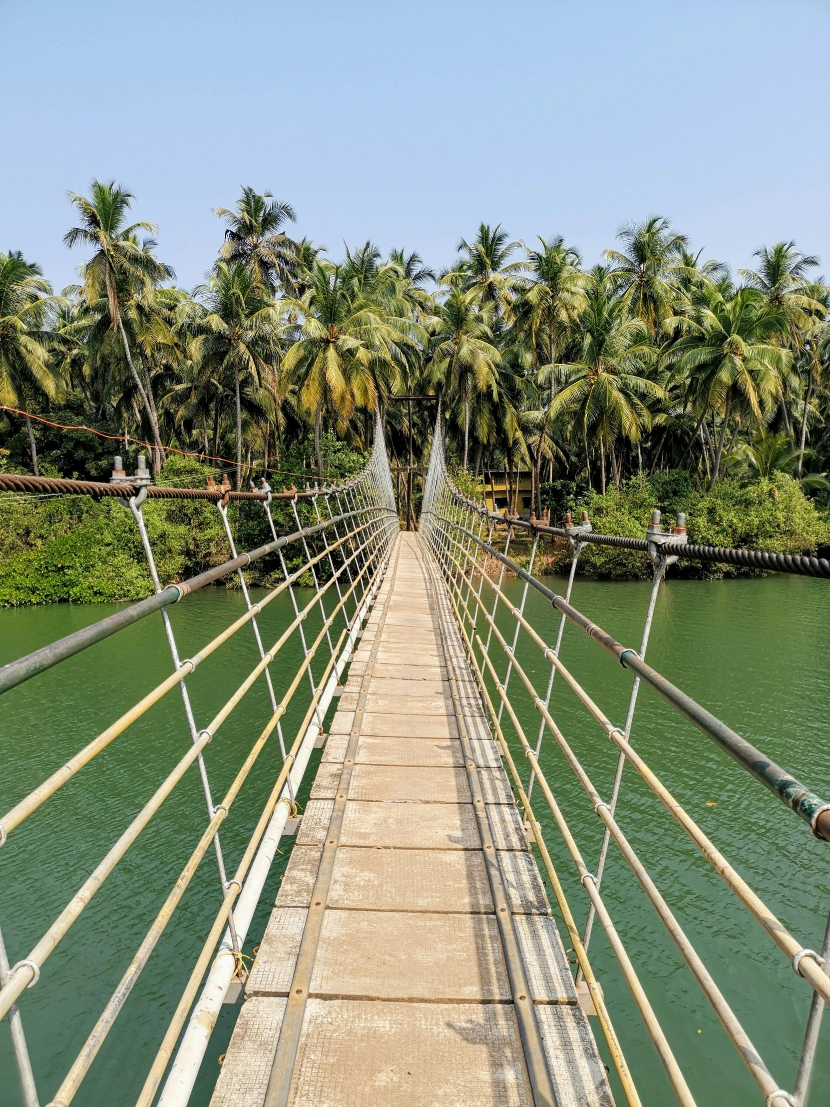 there is a bridge going to the water on the river