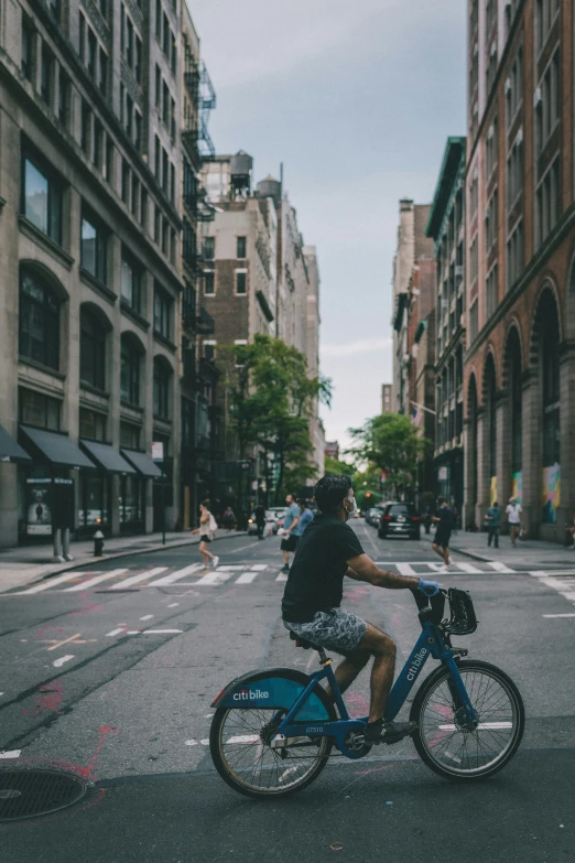 the man is riding his bike on the street