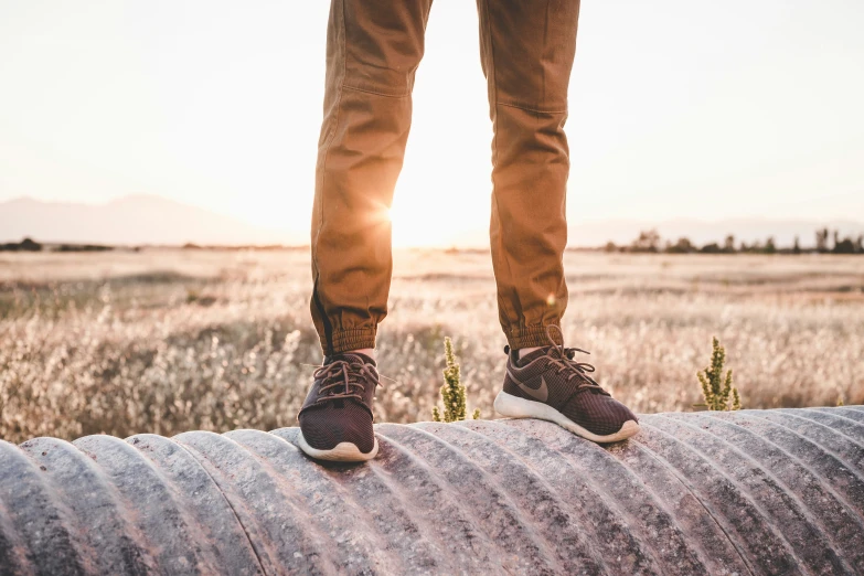 a man's feet on top of the back of an object