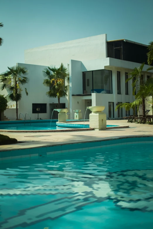 a modern swimming pool with an art deco chair in front of it