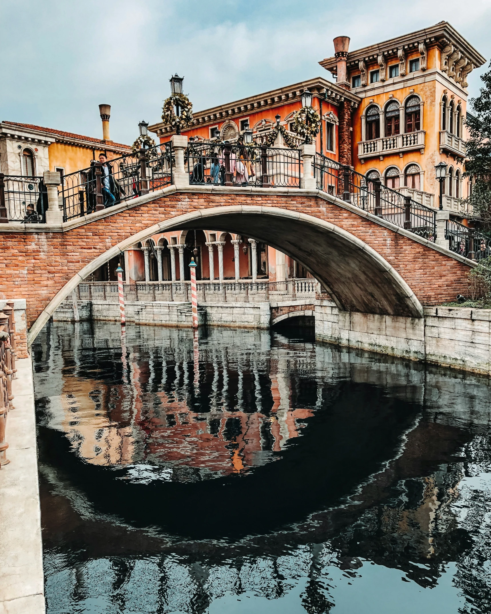 a bridge with people on it and some buildings in the background