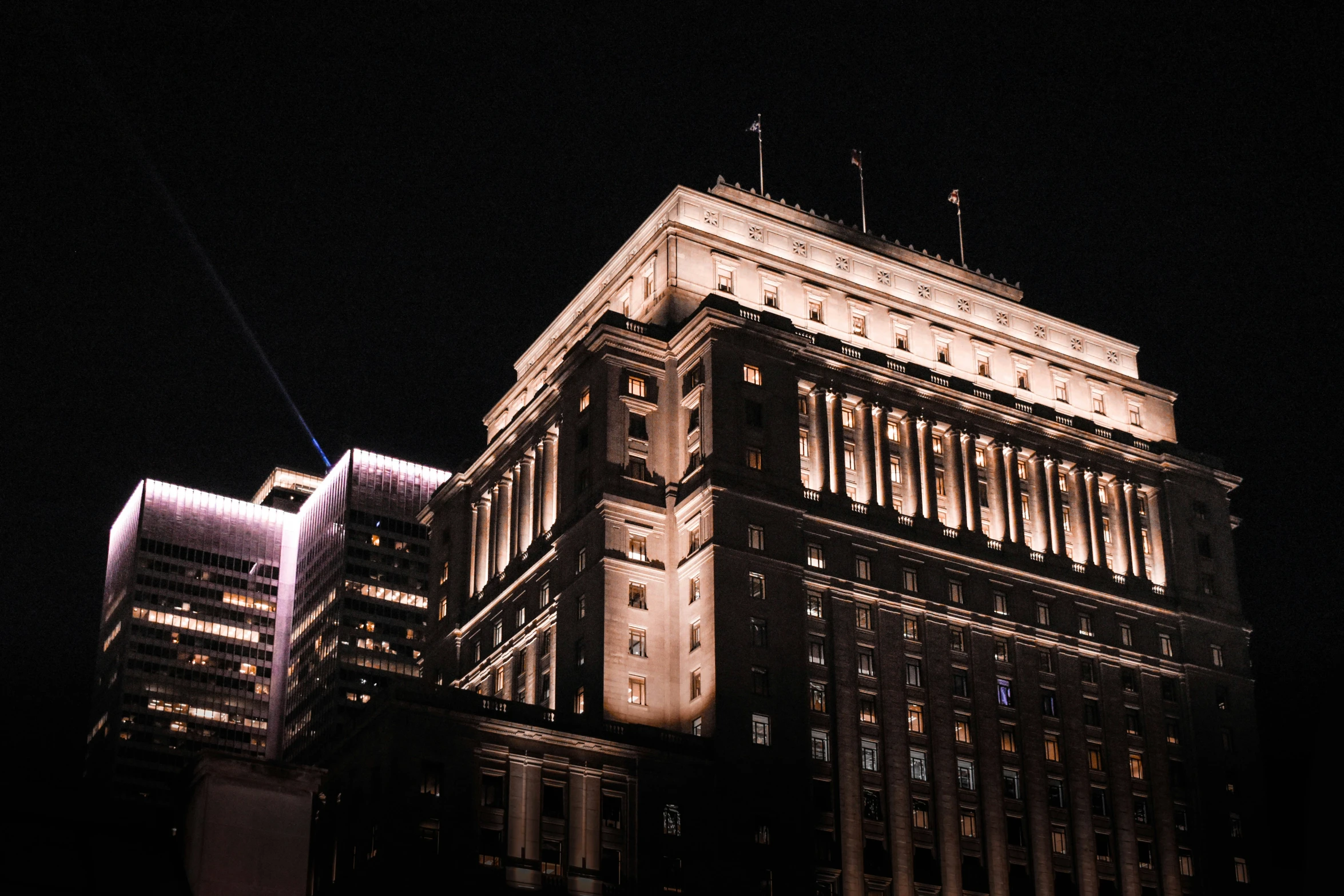 a close up s of a building at night with other buildings