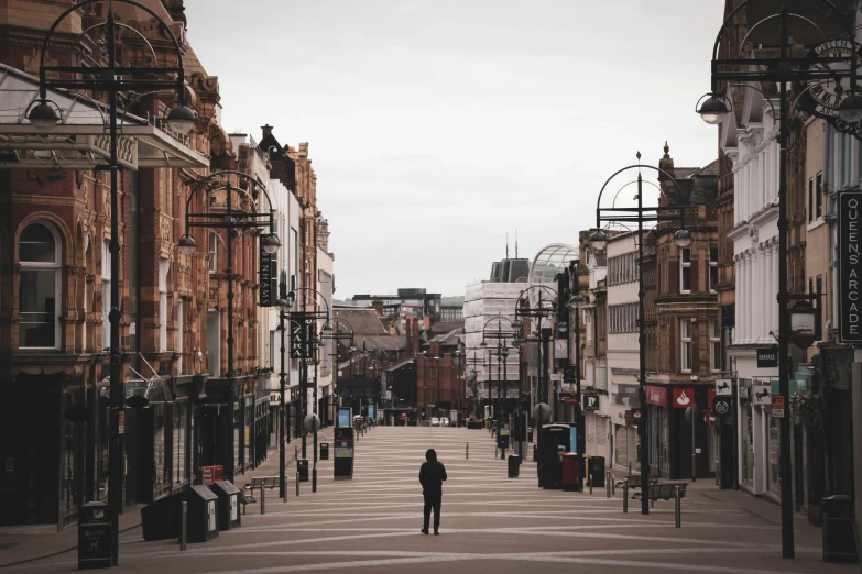 a man walks down a crosswalk in a city
