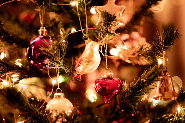 christmas ornaments are hanging from a christmas tree