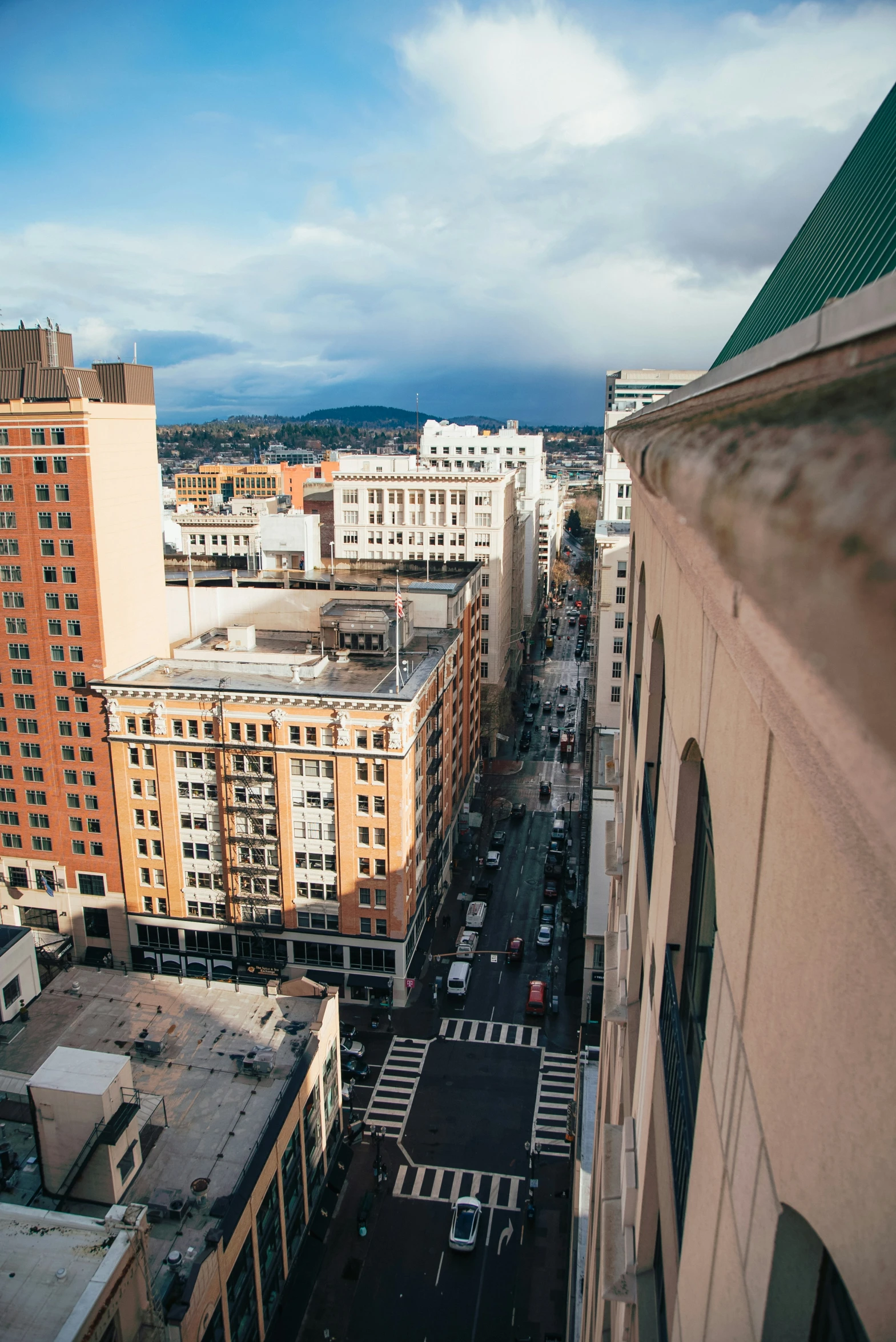 a wide city view with tall buildings and a street