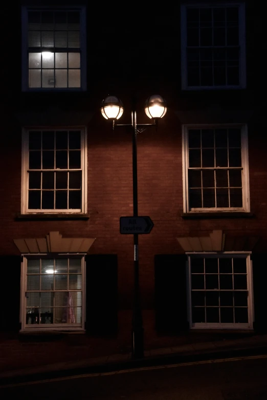 three windows that are next to a lamp post