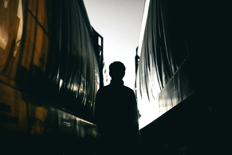 the man is standing in front of a train