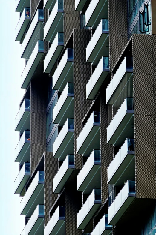 a very tall apartment building with balconies attached to it