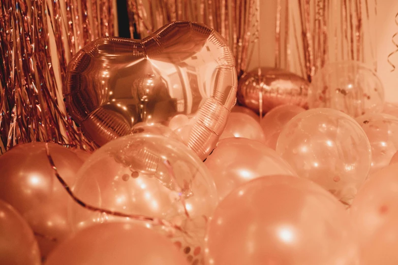 gold and silver balloons in front of a balloon arch
