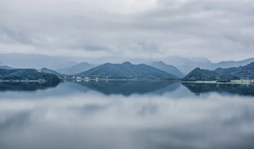 some water mountains and clouds and hills