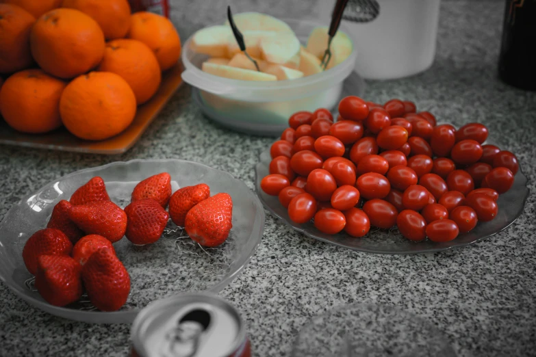 strawberries, peaches and yogurt on plates on the counter