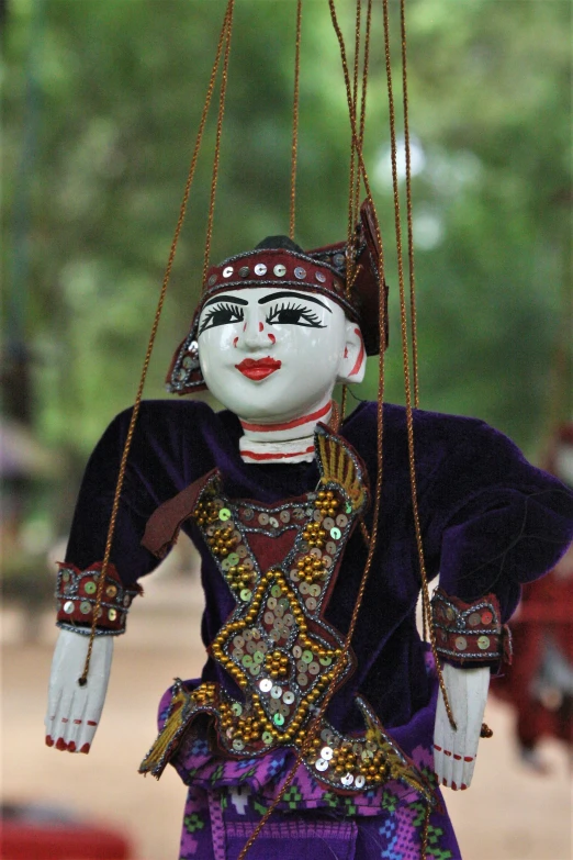 an elaborate marion sits with chains and beads