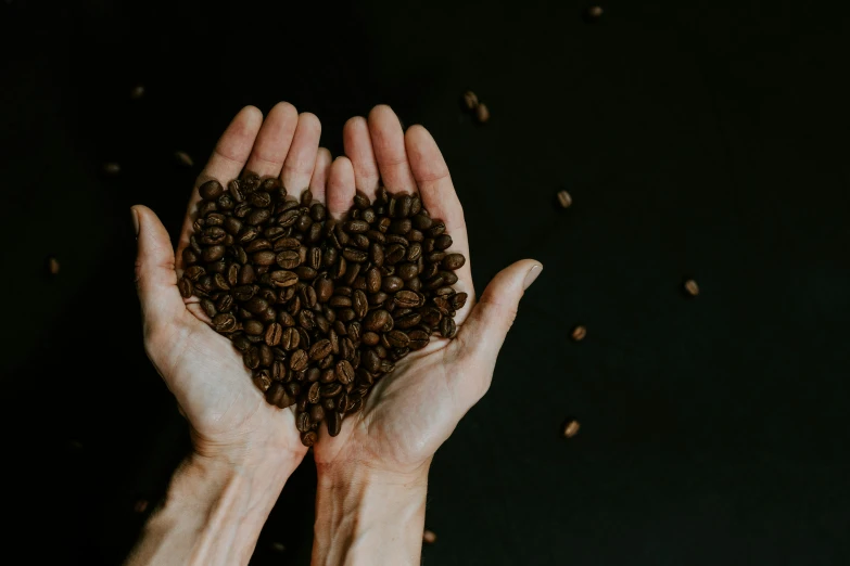 there is a heart shaped arrangement made of coffee beans