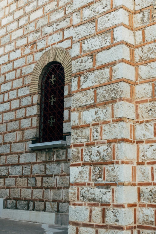 the wall is made of red bricks and has a window