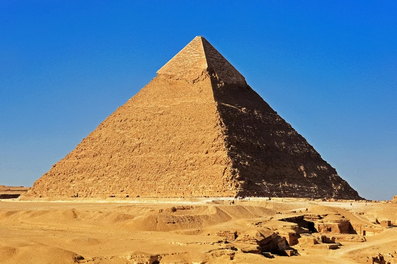 the pyramids in the desert with rocks on the ground