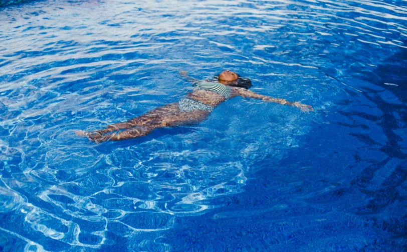 a man is floating on his back in a pool