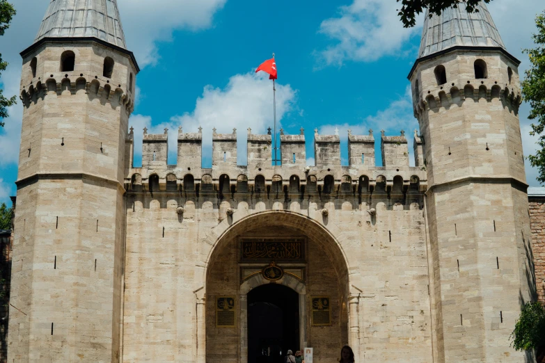 the entrance to an ancient castle with two towers