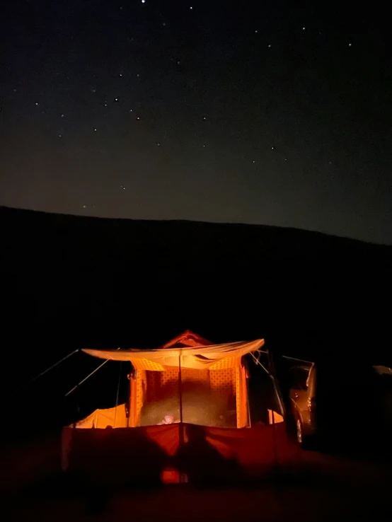a tent is shown as the stars are shining overhead