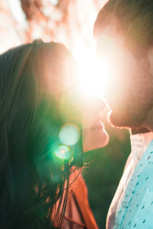 two people close together, in the sunlight