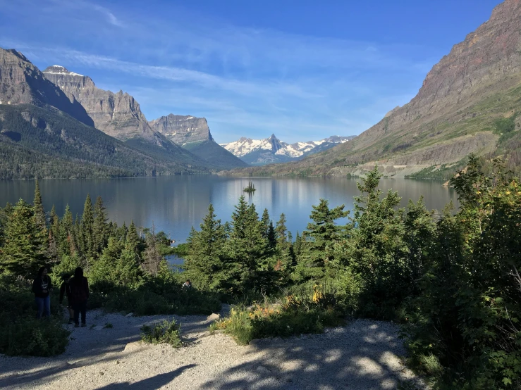 mountains are in the background, with trees and a lake