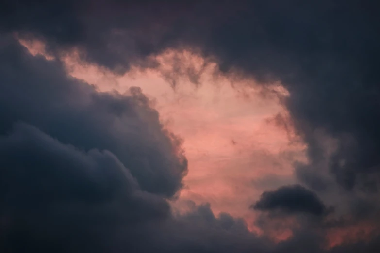 a plane is flying in the dark with clouds