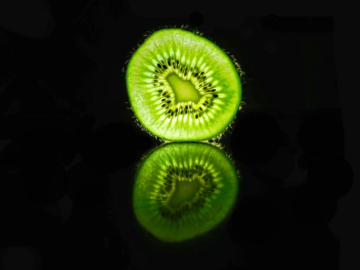 the kiwi is a fruit that is green with yellow markings