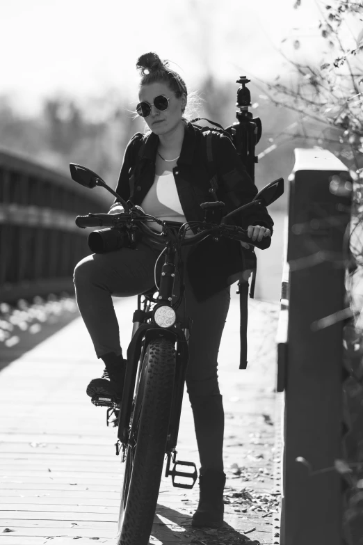 a black and white po of a woman riding a bicycle