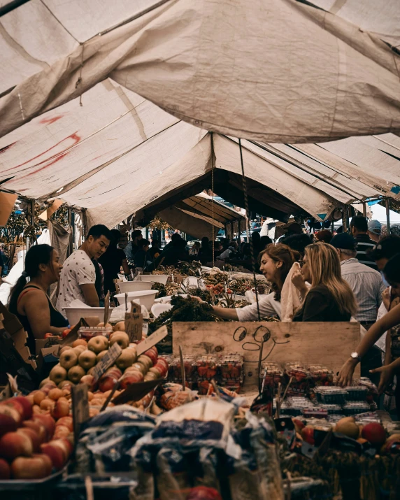 a large open tent is in the shape of a market