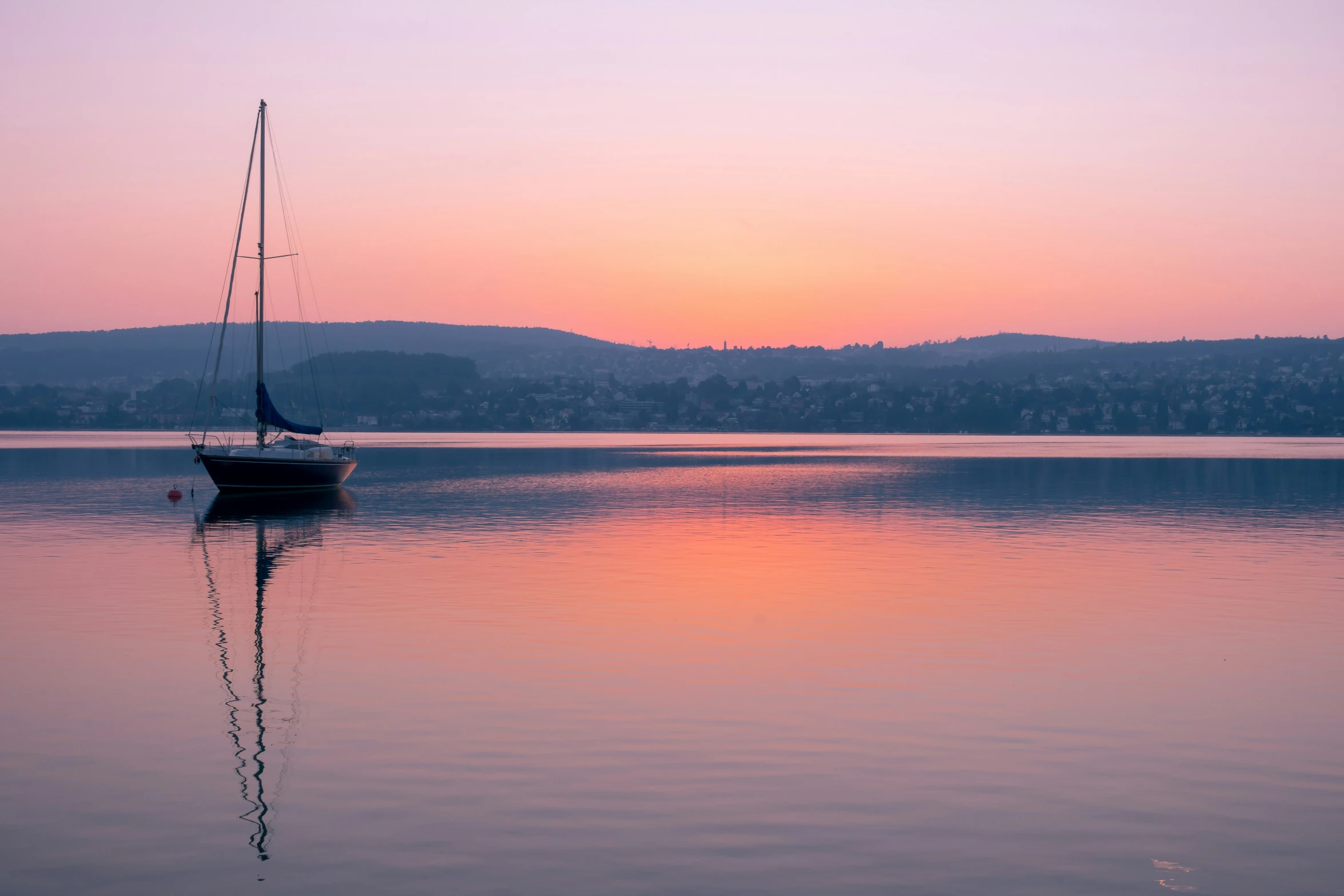 a boat is sitting on the calm water