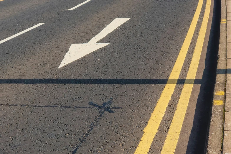 a large road with several white arrows painted on it