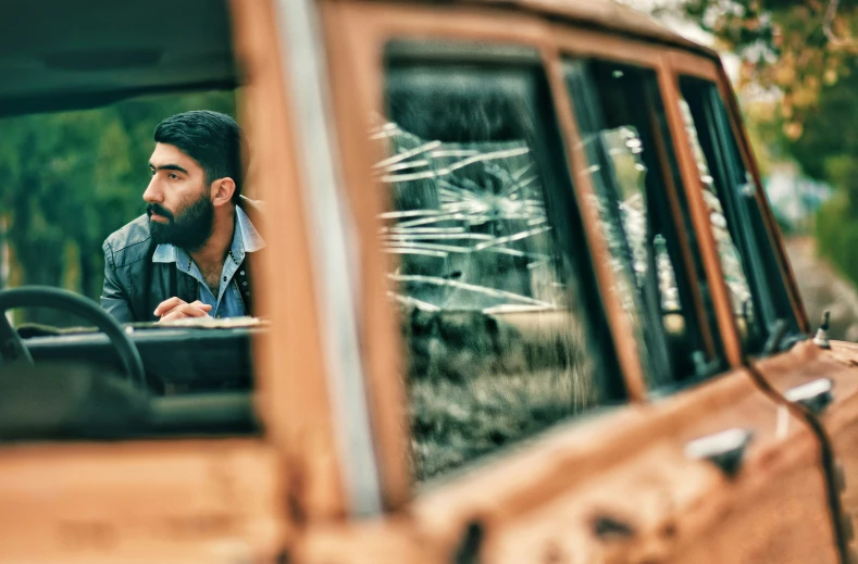 the driver is sitting behind the window of his truck