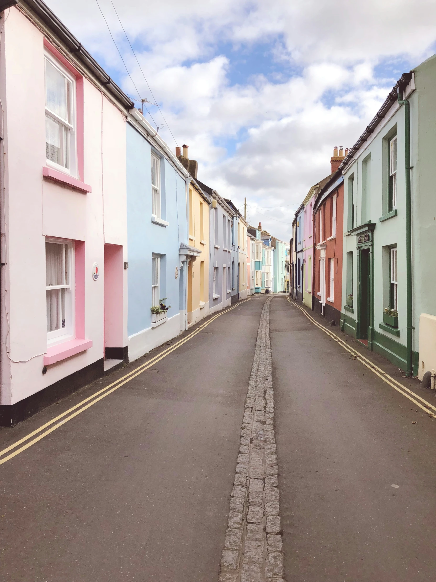 an empty street with several multicolored buildings