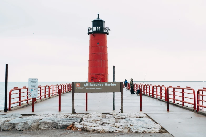 there is a red light house at the pier