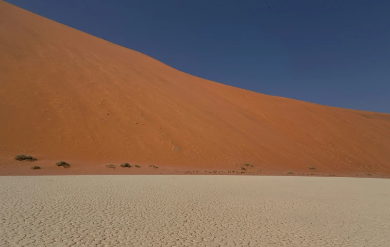 a very tall hill with some sand dunes