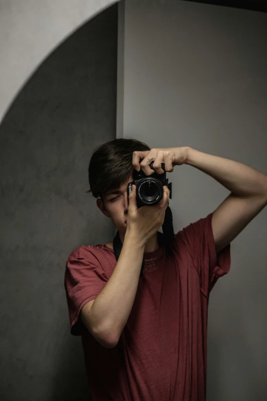 man standing and taking a selfie of himself in front of a mirror