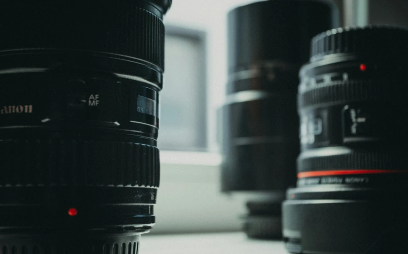 two lens cups on a table next to a window