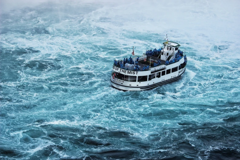 a white cruise ship in the ocean surrounded by blue waters