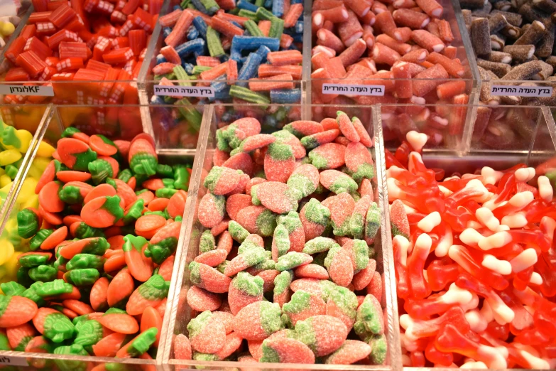 many containers filled with different kinds of sweets