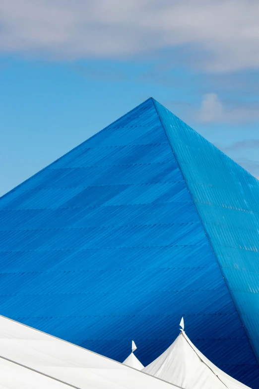 white tent structures with blue sky in background