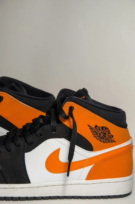 jordan basketball shoe with orange white and black