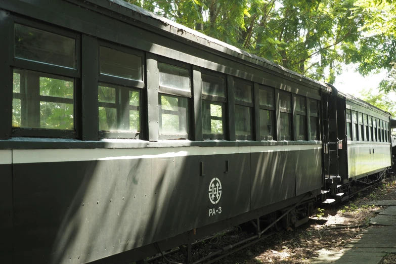 the windows of an old passenger train are open