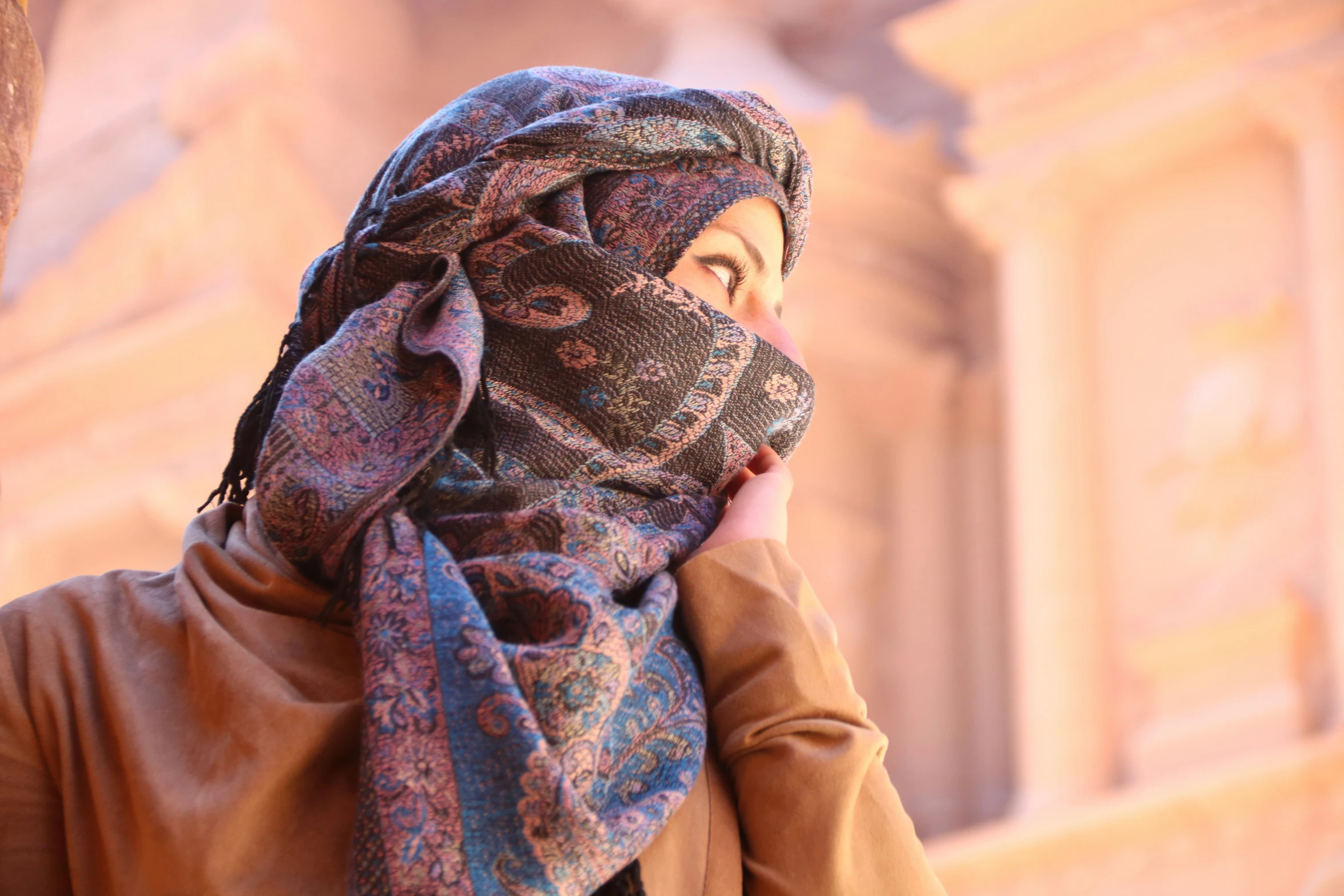 a woman with long hair in a scarf and jacket