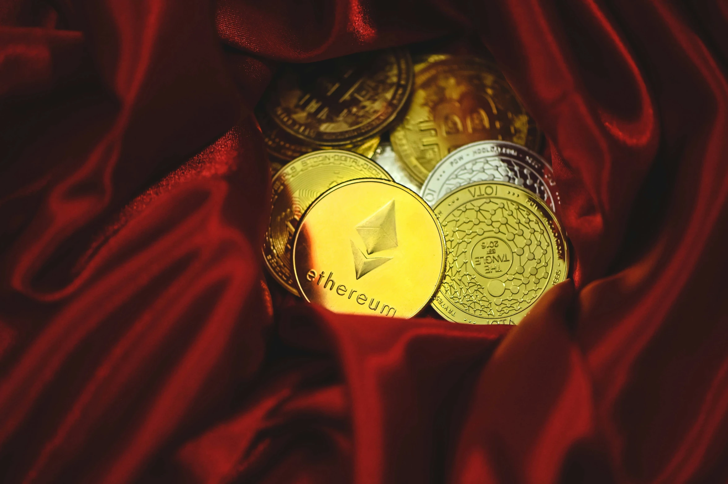 coins are seen laying on red satin with a star decoration