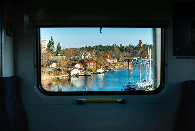 the view from inside a train looking outside the window at the water