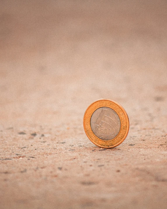 a single orange round on a tan carpet