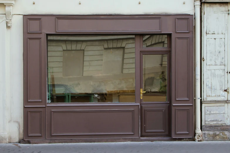 an empty chair and a big window on the building