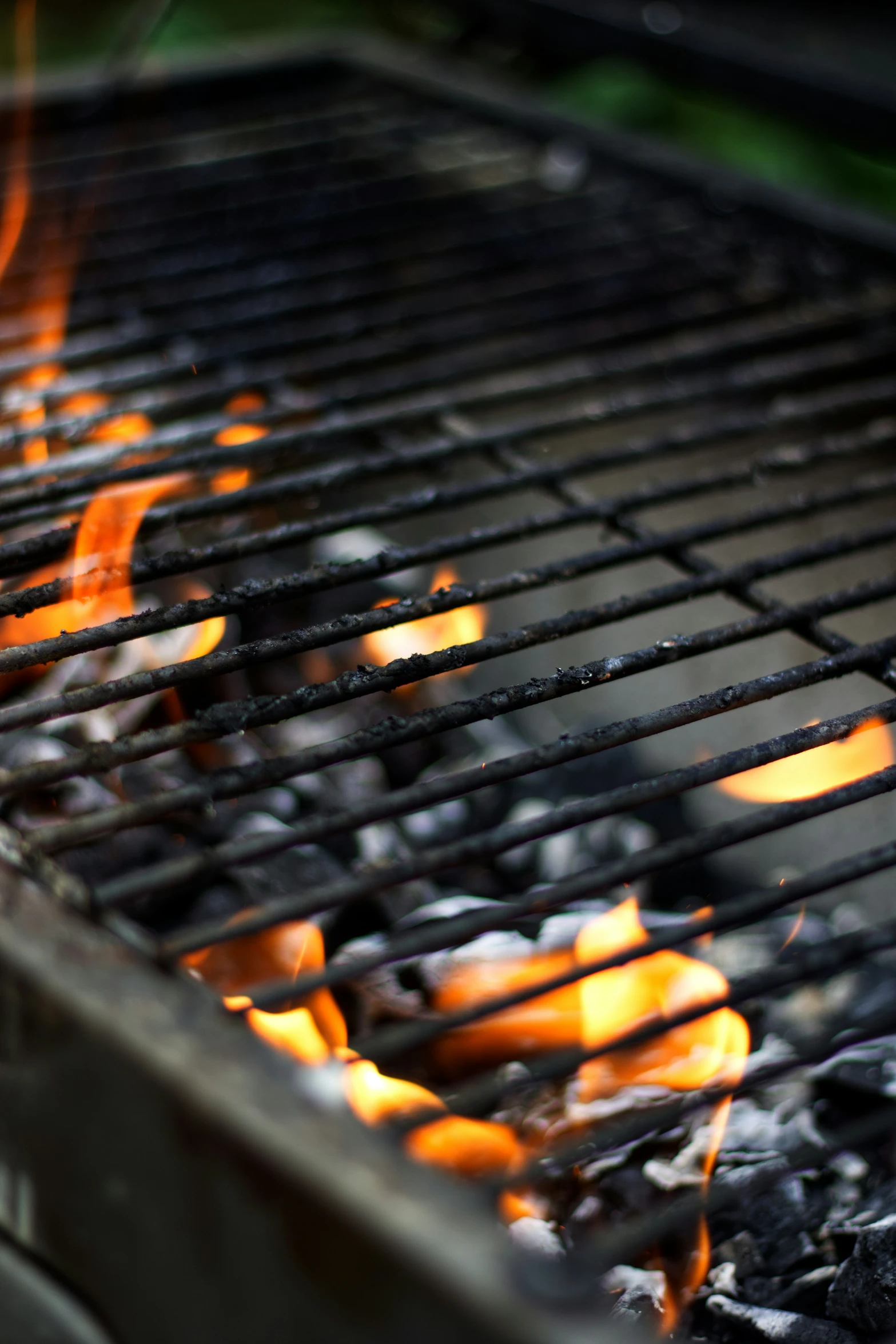 a bbq grill with  coals burning